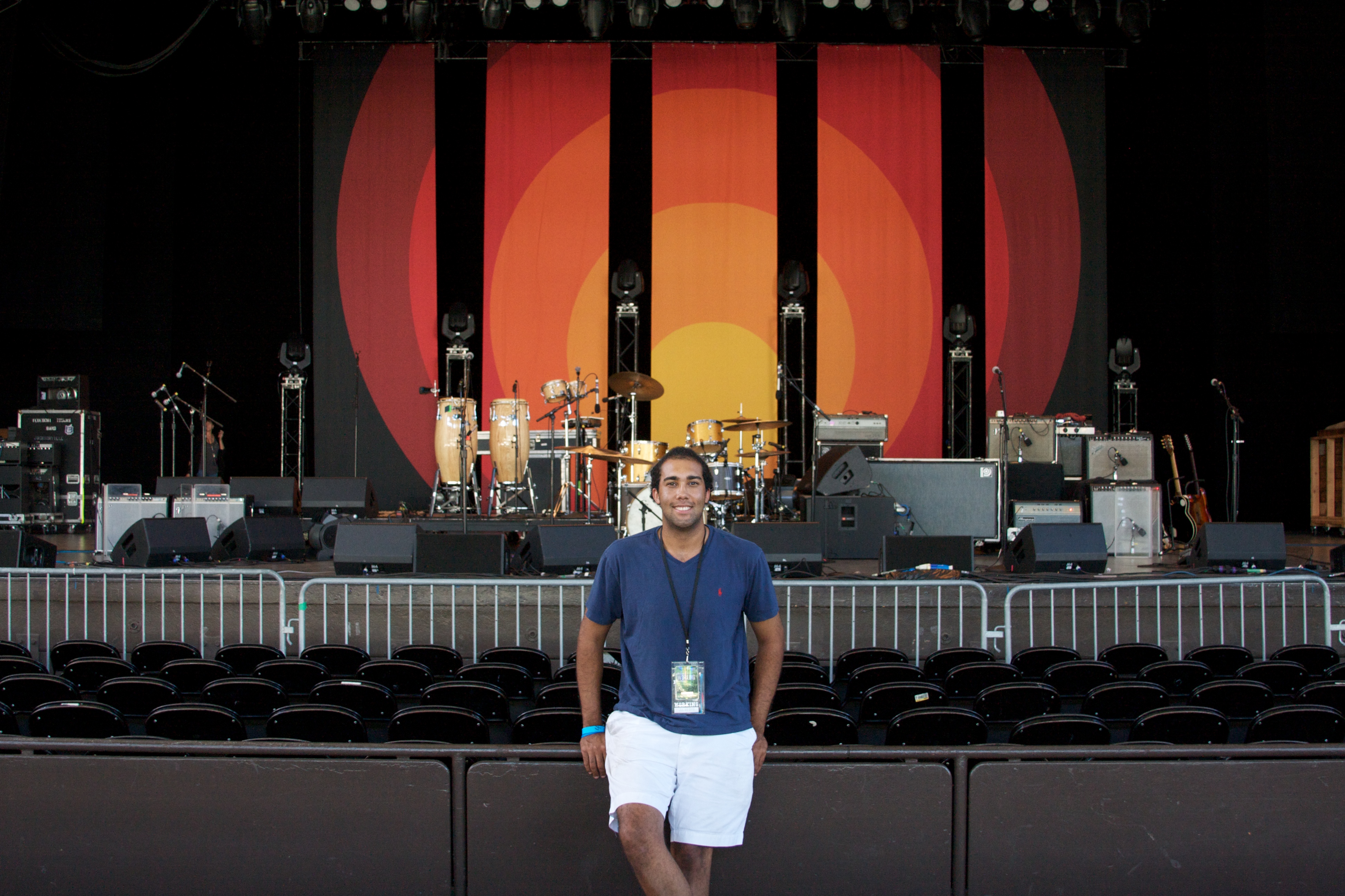 Nathaniel in a blue shirt and white shorts, standing 